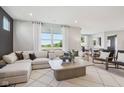 Inviting living room features a comfortable sectional sofa, large windows, and seamless connection to the outdoors at 6851 Jacone Dr, Brownsburg, IN 46112