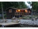 Cozy cabin with waterfront access, wooden decks, and landscaping for peaceful lake living and relaxing outdoors at 6937 Muskrat Dr, , IN 46164