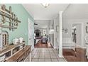 Inviting home entrance with hardwood floors and views of the living area, including a brick fireplace at 7221 State Road 42, Martinsville, IN 46151