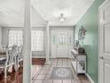 Elegant foyer showcasing decorative tile, a glass-paneled door, and views into the formal dining space at 7221 State Road 42, Martinsville, IN 46151