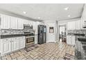 Beautiful kitchen with white cabinets, stainless steel appliances, and tile flooring at 7221 State Road 42, Martinsville, IN 46151