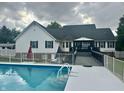 Back of house featuring an in-ground pool with a deck and a covered patio at 7221 State Road 42, Martinsville, IN 46151