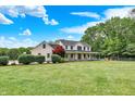 Lovely two-story home with a wide front yard, mature trees, and a charming covered porch at 7380 N 225 W, Lebanon, IN 46052