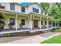 Inviting front porch with rocking chairs and brick accents, offering a relaxing outdoor space at 7380 N 225 W, Lebanon, IN 46052