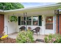 Inviting front porch with charming decor, cozy seating, and blooming flowers at 8027 S 250 E, Markleville, IN 46056
