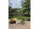 Backyard featuring a small pond surrounded by a wooden fence, and gardening equipment at 10194 Lothbury Cir, Fishers, IN 46037