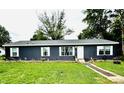 Charming single-story home showcasing blue siding, white trim, and a well-manicured lawn at 125 W Church St, Thorntown, IN 46071