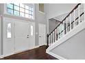 Bright foyer featuring a grand staircase, beautiful flooring and a transom window at 1410 Shadow Ct, Zionsville, IN 46077