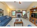 Cozy living room with fireplace, plush blue seating, and neutral carpet is an inviting space at 1607 Michelle Manor, Danville, IN 46122
