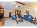 Bright living room with high ceilings, ceiling fan and comfortable seating offers a cozy atmosphere at 1607 Michelle Manor, Danville, IN 46122