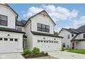 Beautiful home with a white facade, black trim, attached garage, and well-manicured yard at 17551 Gruner Way, Westfield, IN 46062