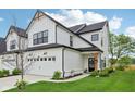 Beautiful home with a white facade, black trim, attached garage, and inviting front entrance at 17551 Gruner Way, Westfield, IN 46062