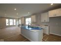 Open concept kitchen features a large island, ample counter space, and sleek white cabinetry at 1813 Real St, Indianapolis, IN 46240