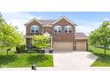 Charming brick two-story home with manicured lawn, mature trees, and a spacious two-car garage at 1821 Midnight Pass, Brownsburg, IN 46112