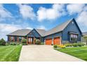 The stunning home features a three-car garage, manicured lawn, and a spacious driveway at 18398 Cross Lakes Ct, Westfield, IN 46074