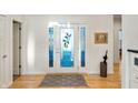 Bright entryway with hardwood floors and decorative glass front door at 201 St Andrews Ave, Edinburgh, IN 46124