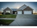 Stunning front exterior with a lush green lawn and a two-car garage at 201 St Andrews Ave, Edinburgh, IN 46124