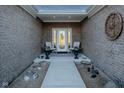 Inviting front porch with chairs and decor, set within a brick-lined entry at 201 St Andrews Ave, Edinburgh, IN 46124