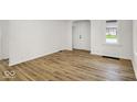 Bright living room with wood-look flooring and a fresh, neutral color palette at 2015 S Hackley St, Muncie, IN 47302