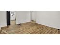 The living room boasts new flooring and leads into the updated kitchen at 2015 S Hackley St, Muncie, IN 47302