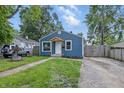 Blue house with an inviting driveway and well maintained yard at 2315 Spann Ave, Indianapolis, IN 46203