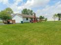 Expansive backyard featuring a deck, lush lawn, and mature trees providing a serene outdoor space at 2625 S 200 E, Lebanon, IN 46052