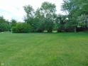 View of the spacious yard with mature trees and lush greenery providing a serene atmosphere at 2625 S 200 E, Lebanon, IN 46052