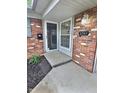 The front door to 2741, surrounded by decorative brick, leads into the home at 2741 Fairlawn Dr, Columbus, IN 47203