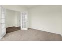 Spacious carpeted bedroom with white french doors and trim at 2750 Glade Ave, Plainfield, IN 46168