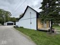 Side view of a two-story home, showcasing its mixed siding, clean lines, and a detached garage at 317 W Pierson St, Greenfield, IN 46140