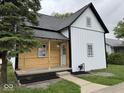 Inviting two-story home with mixed siding and a cozy front porch, perfect for relaxing outdoors at 317 W Pierson St, Greenfield, IN 46140