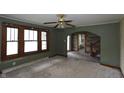 Inviting living room featuring original windows, carpet, and an archway leading to the rest of the home at 364 S Cole St, Indianapolis, IN 46241
