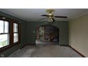 Inviting living room featuring original windows, carpet, and an archway leading to the rest of the home at 364 S Cole St, Indianapolis, IN 46241
