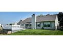 The house has a white deck and a green lawn, and the house is sided in gray with gray shingles at 3959 Towhees Dr, Indianapolis, IN 46237
