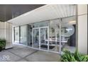 Modern building entrance featuring expansive glass windows with a covered entry at 3965 N Meridian St # 3J West, Indianapolis, IN 46208