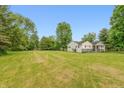 Expansive view of a well-maintained home with a spacious front yard and beautiful surrounding greenery at 4195 Locust Ln, Brownsburg, IN 46112