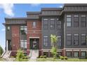 Modern townhouse with brick and composite siding, front door and steps at 420 Monon Wy Dr, Carmel, IN 46032