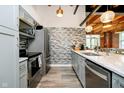Modern kitchen featuring stainless steel appliances, tile backsplash, and a sleek design at 430 N Park Ave # 211, Indianapolis, IN 46202