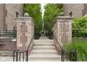 Inviting gated entrance with brick pillars and decorative ironwork leading to the courtyard at 450 E Ohio St # Apt 305, Indianapolis, IN 46204