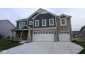 Beautiful two-story home with a stone and dark siding exterior and a spacious two-car garage at 4947 Amber Crest Dr, Brownsburg, IN 46112