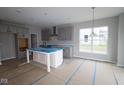 Modern kitchen with gray cabinetry, a central island, and stainless steel appliances at 4947 Amber Crest Dr, Brownsburg, IN 46112