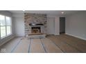 Bright living room showcasing a stone fireplace, perfect for cozy gatherings at 4947 Amber Crest Dr, Brownsburg, IN 46112