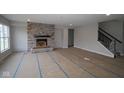 Spacious living room featuring a stone fireplace and large windows for ample natural light at 4947 Amber Crest Dr, Brownsburg, IN 46112
