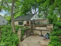 Charming exterior showcasing the house's design with its lush surroundings and interesting architectural elements at 5035 Boulevard Pl, Indianapolis, IN 46208