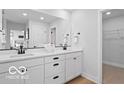 Modern bathroom with double sinks, a large mirror, and stylish black hardware at 5925 Sterling Dr, Whitestown, IN 46075