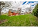 Large backyard featuring a detached garage, a chain-link fence, and ample green space at 5939 Olivia Dr, Alexandria, IN 46001