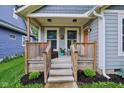 Inviting front porch with cozy seating, showcasing a charming entryway for a welcoming curb appeal at 617 N Dearborn St, Indianapolis, IN 46201