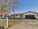 Charming single-story home with attached garage and well-maintained lawn at 619 Belzer Dr, Anderson, IN 46011