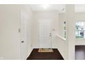Bright foyer with hardwood floors, white walls, and a cheerful welcome mat at 630 Harmony Way, Greenwood, IN 46143