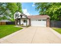 Two-story home with brick and siding, attached garage and inviting curb appeal at 8416 Buckingham Dr, Columbus, IN 47201